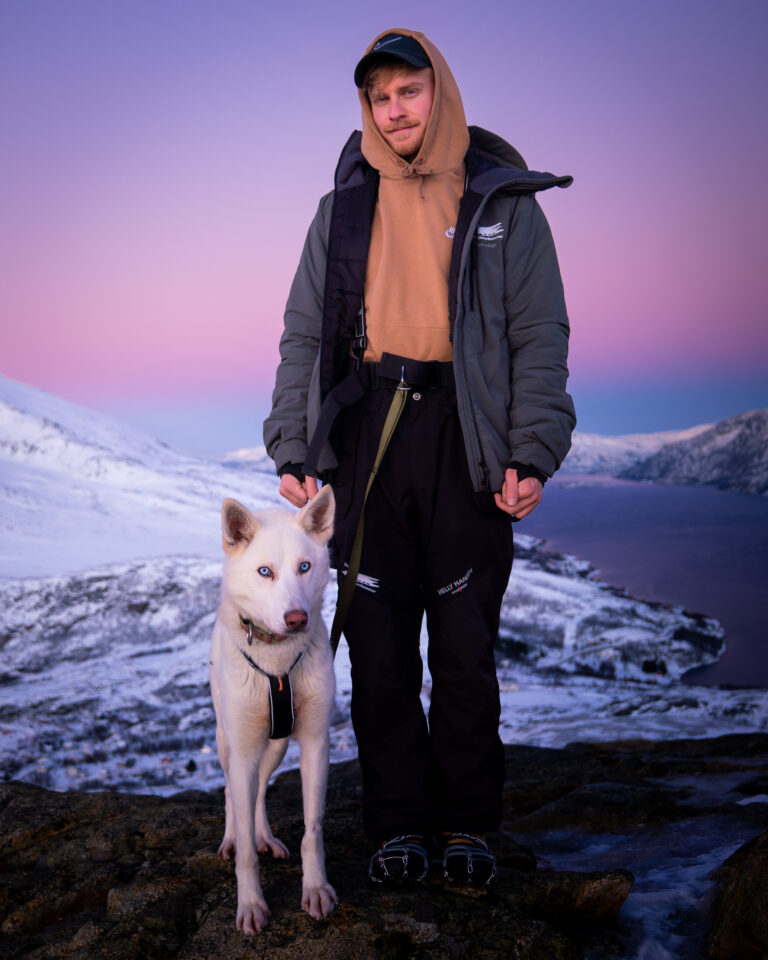 Slavomír Žáň with an Alaskan husky in the snowy mountains near Tromsø